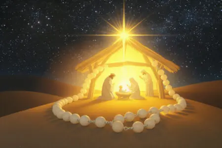 prikaz kako se moli radosna krunica s krunicom koja okružuje prizor isusovog rođenja